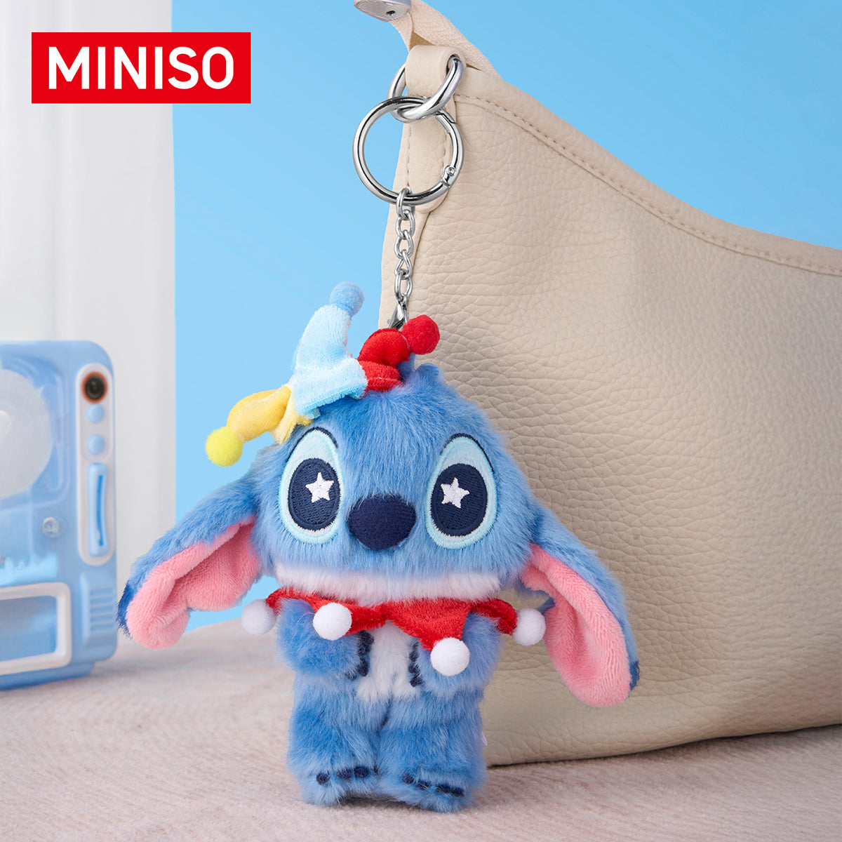 Disney Stitch Surprise Clown plush keychain hanging on a bag
