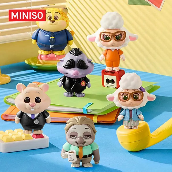 Disney Zootopia Daily Life Dress-Up blind box figures displayed together on a colorful desk scene with notebooks and office props.