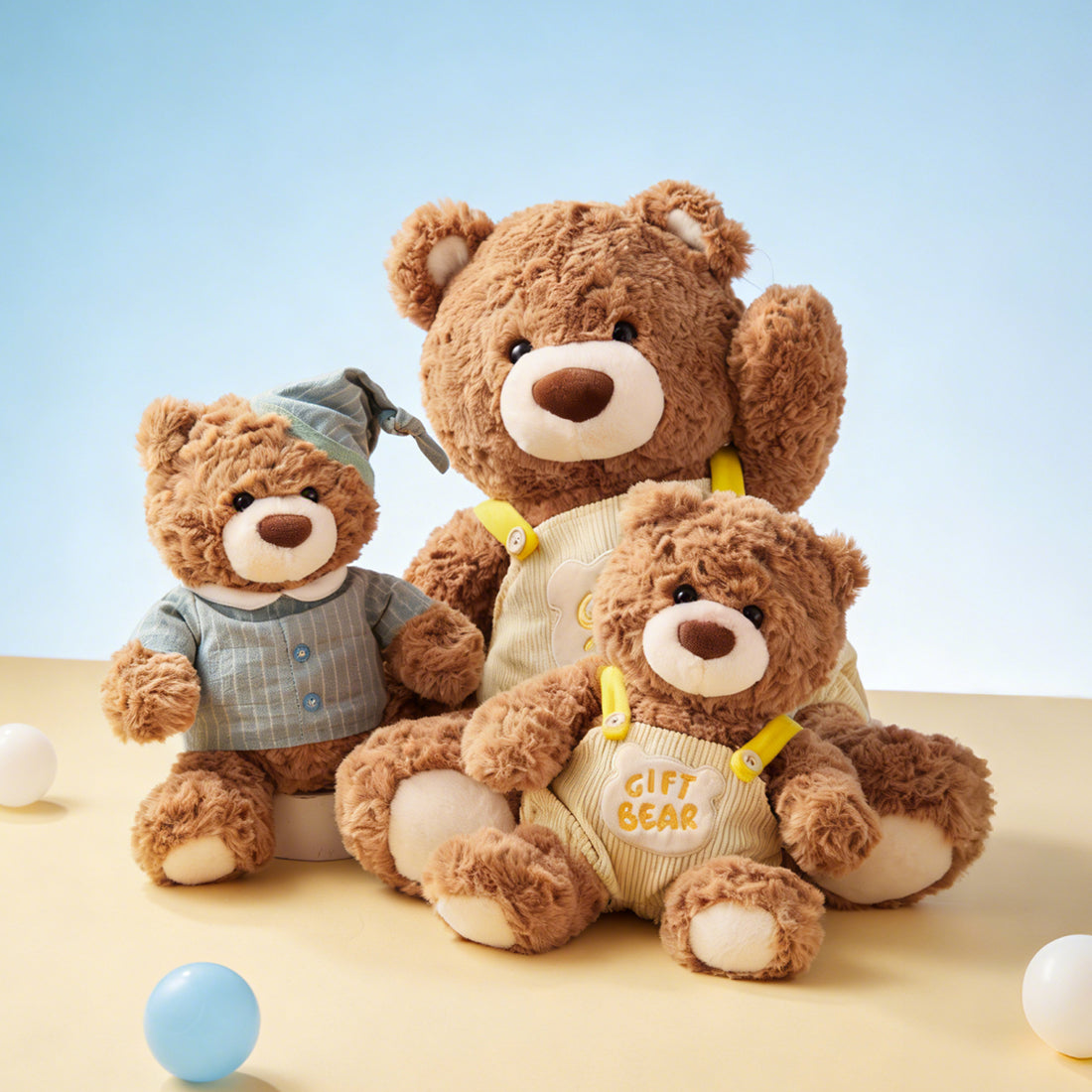 Gift Bear Series Overall Sitting Plush Doll displayed with other teddy bear styles, showing the seated overall bear in a soft brown plush finish.