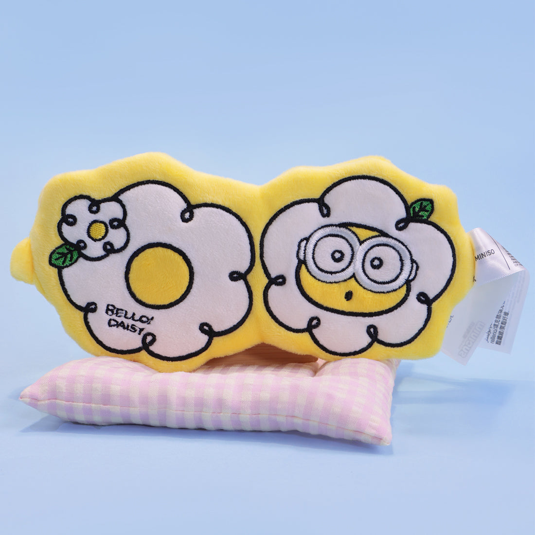 MINISO Minion flower eye mask resting on striped cushion