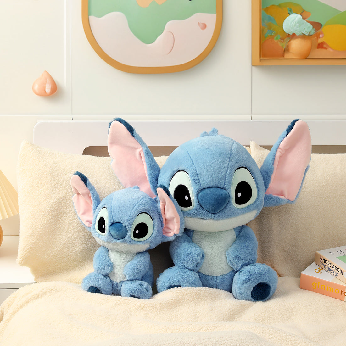 MINISO Disney Stitch classic plush toys in two sizes displayed together on a bedroom sofa