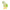 Green YOYO Wishing Heart figure holding four‑leaf clover